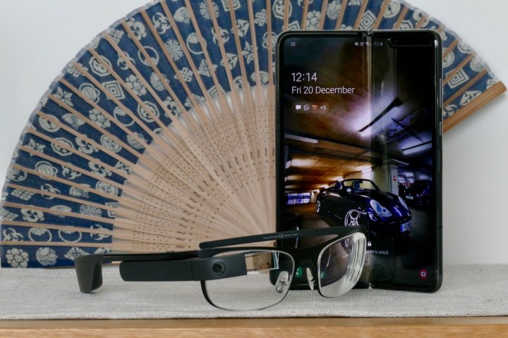 Google Glass and the Samsung Galaxy Fold together, on a table in front of a fan.