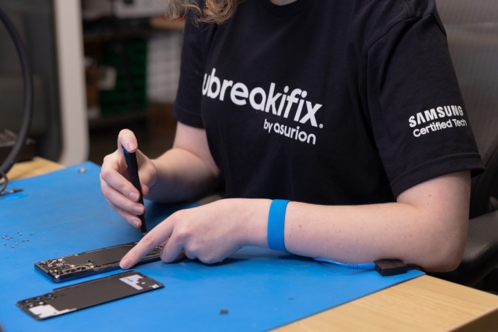 A person repairing a Samsung phone.