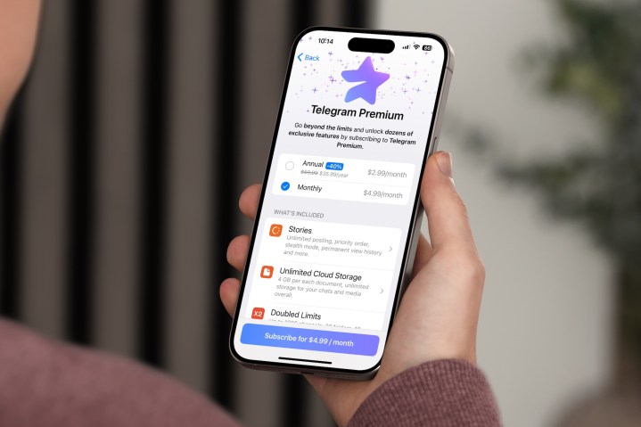 Person holding an iPhone with the Telegram Premium order page showing.