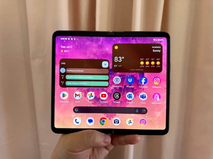 Someone holding a Google Pixel Fold in hand with inner display showing.