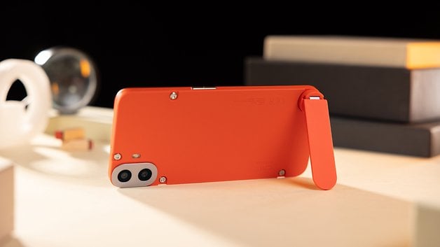 The CMF Phone 1 seen from behind and placed horizontally, with its stand attached.