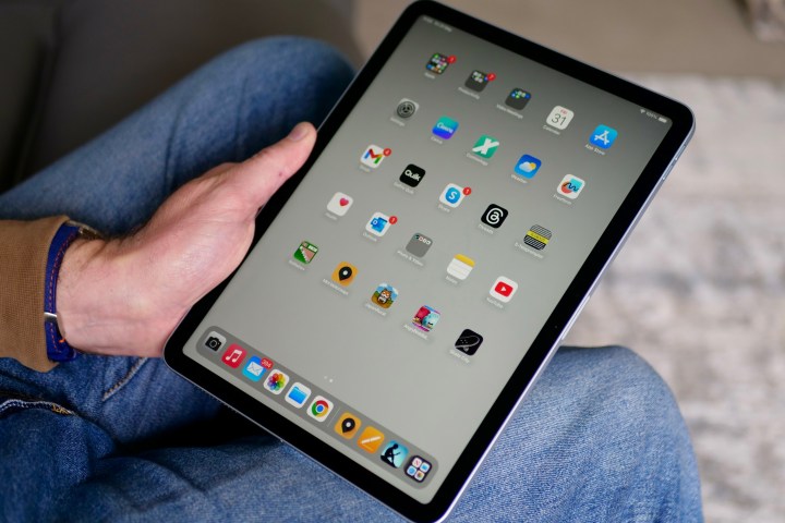 A person holding the Apple iPad Air (2024), showing the screen.