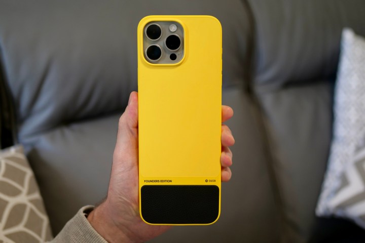 A person holding the iPhone 15 Pro Max inside the Clicks Keyboard case.