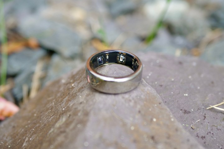 The Oura Ring resting on a rock.