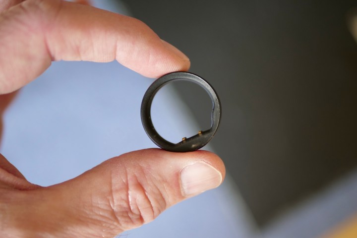 A person holding the Circular Ring Slim smart ring.