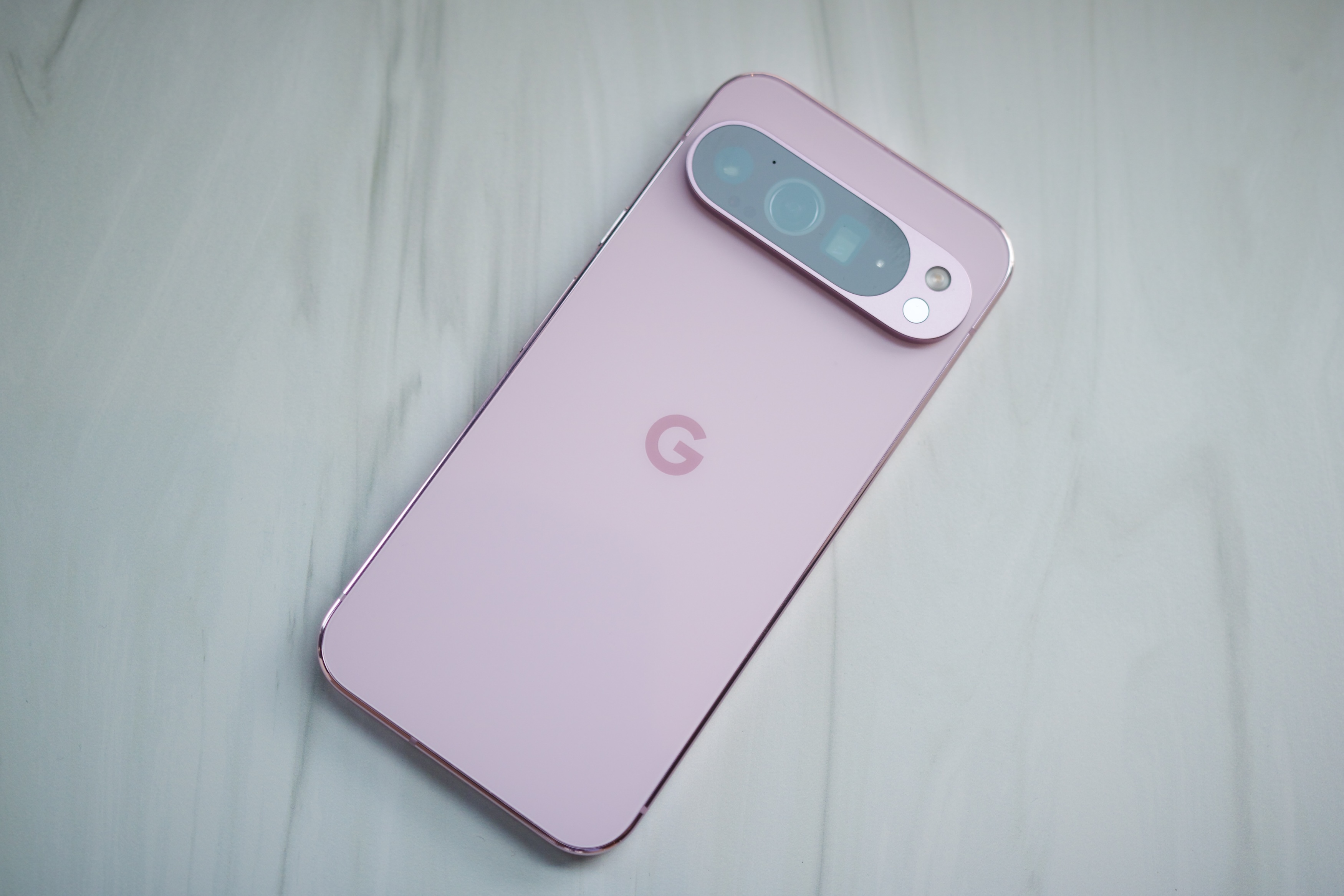 A pink Google Pixel 9 Pro XL laying down.