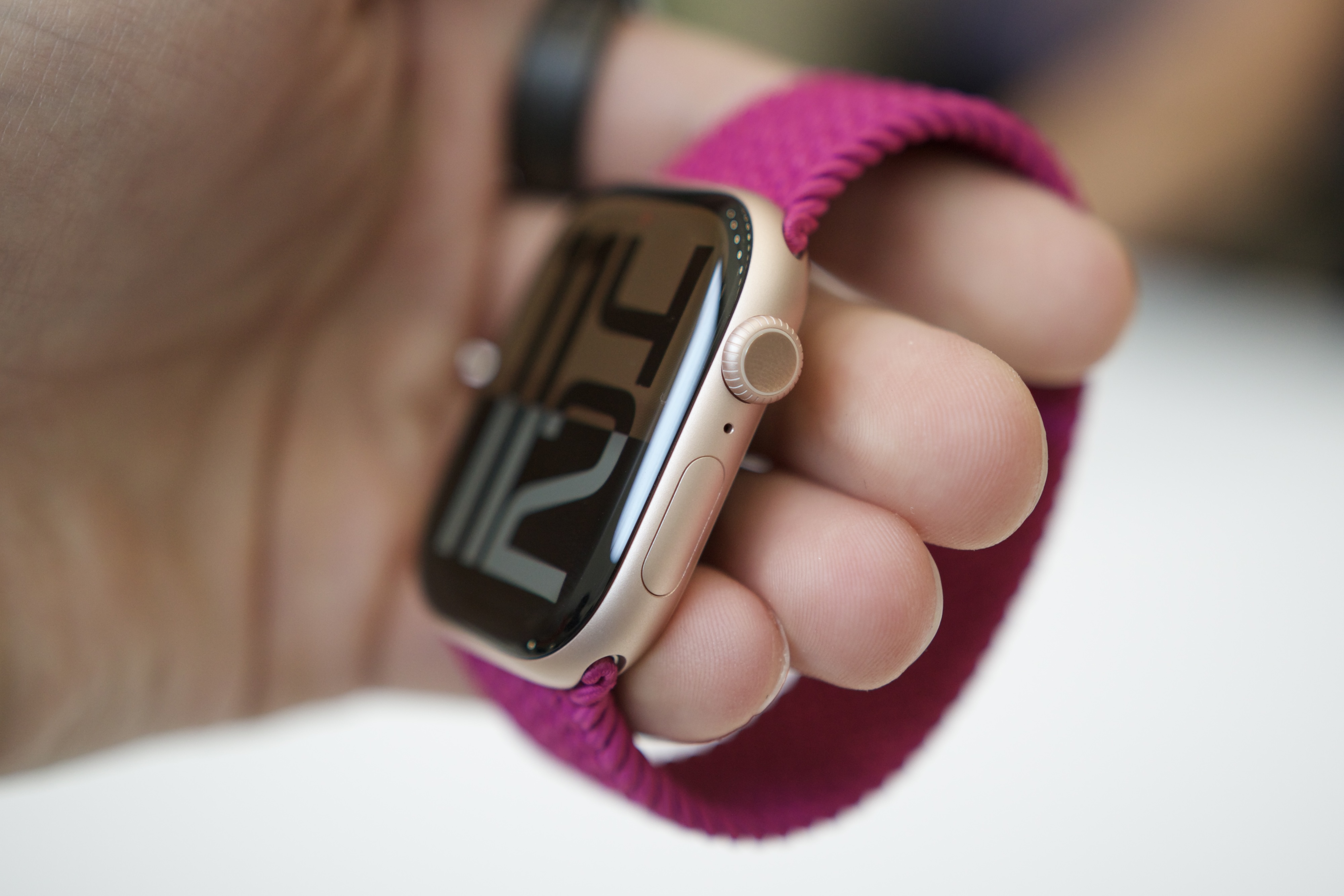 The Apple Watch Series 10, being held by someone and viewed from an angle.