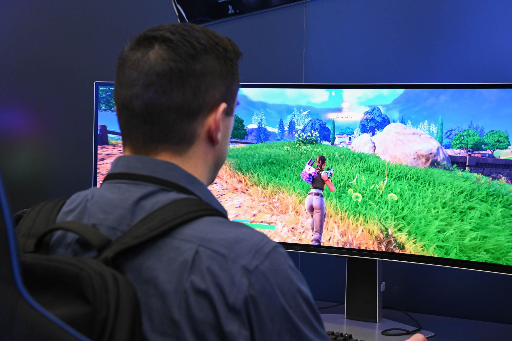 Person playing Fortnite on a Samsung Odyssey Curved Monitor at CES 2024.