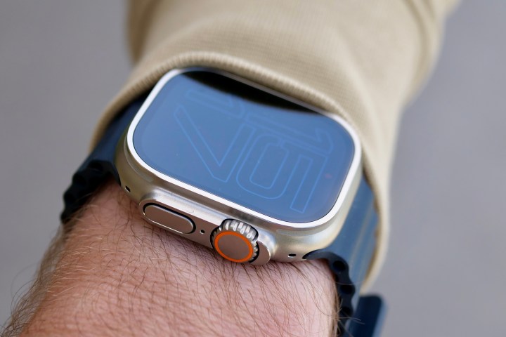 A person wearing the Apple Watch Ultra, seen from the side.