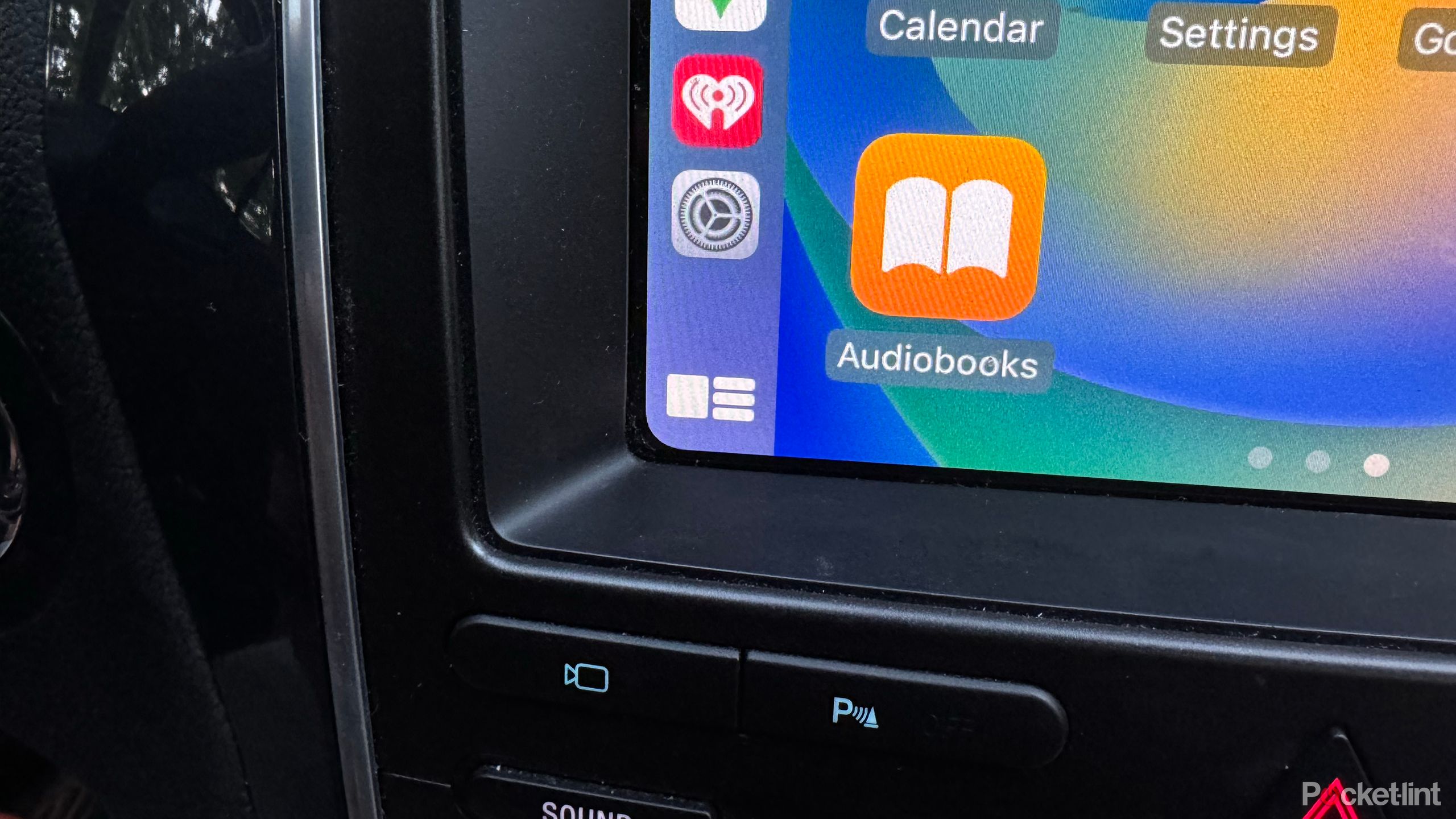 A car's infotainment screen displays Apple CarPlay