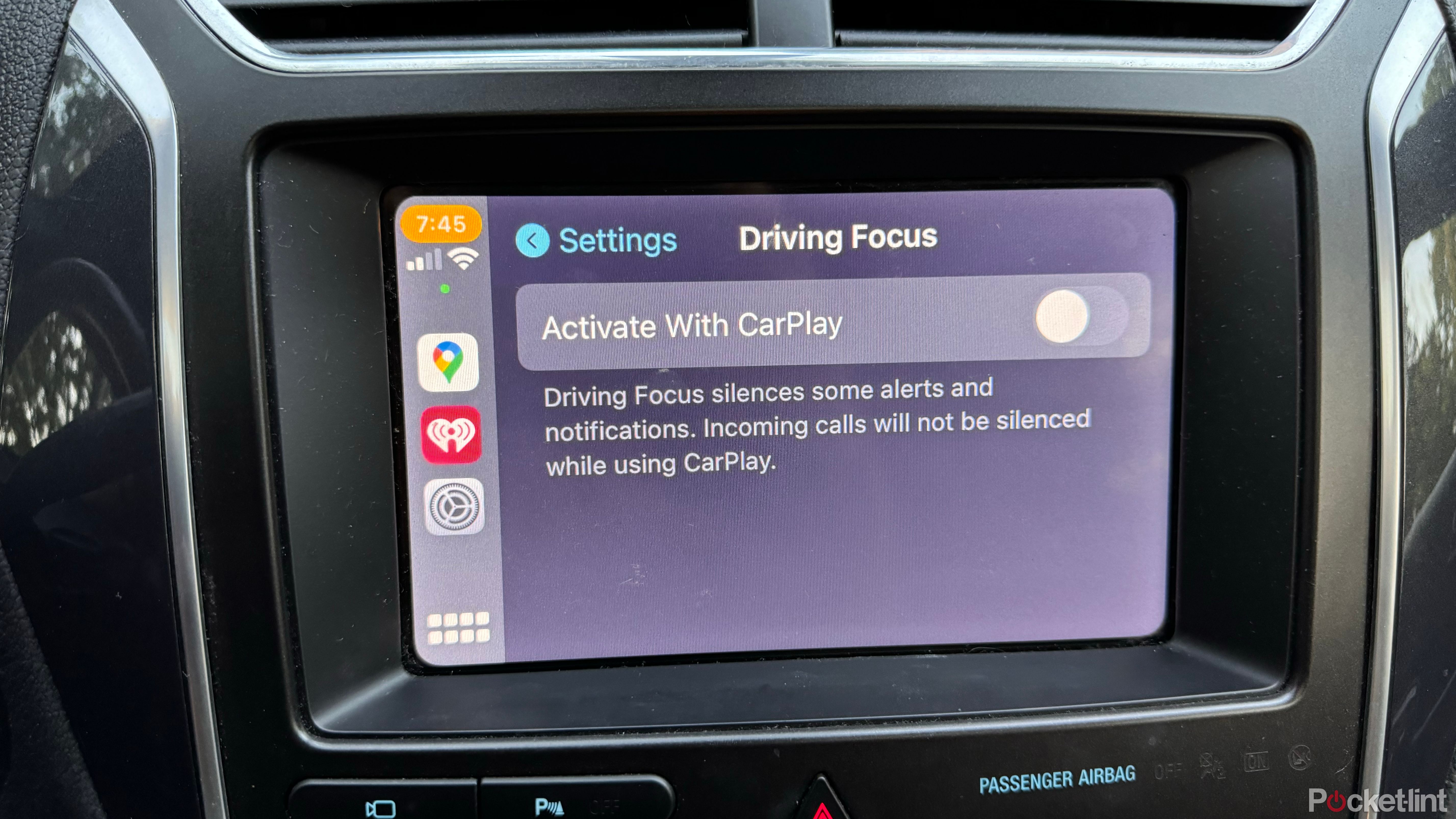 A car's infotainment screen displays Apple CarPlay Driving Focus