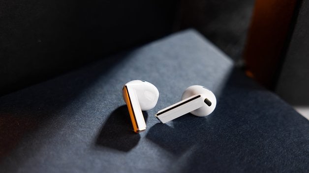 Samsung Galaxy Buds 3 in white, tilted to show the design and shadows.