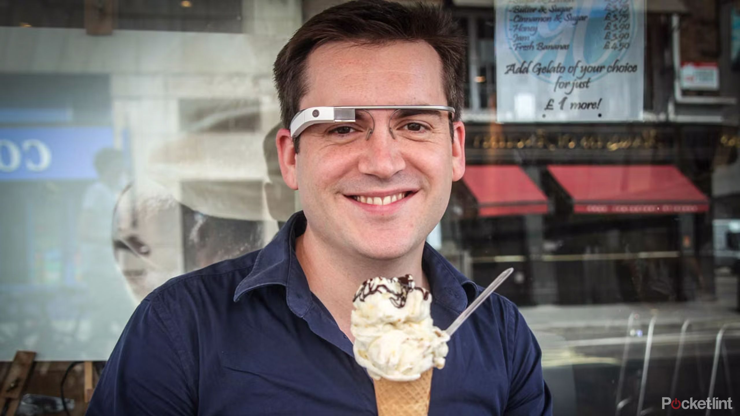 A man wearing Google Glass holding an ice cream