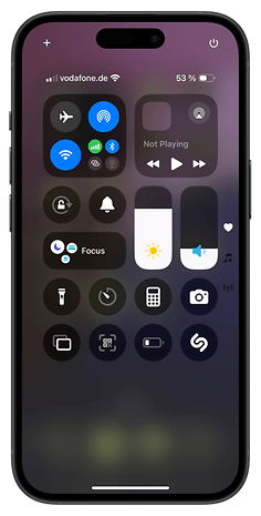 An iPhone 16 screen showing the Control Center with various icons and options.