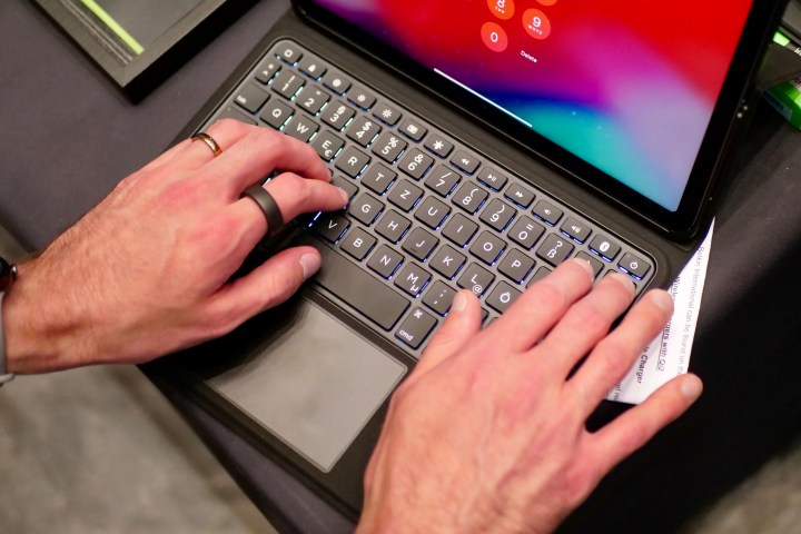 A person typing on the Belkin Everyday Keyboard Case and Cradle for the Apple iPad.