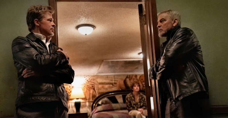 George Clooney and Brad Pitt stand in a doorway