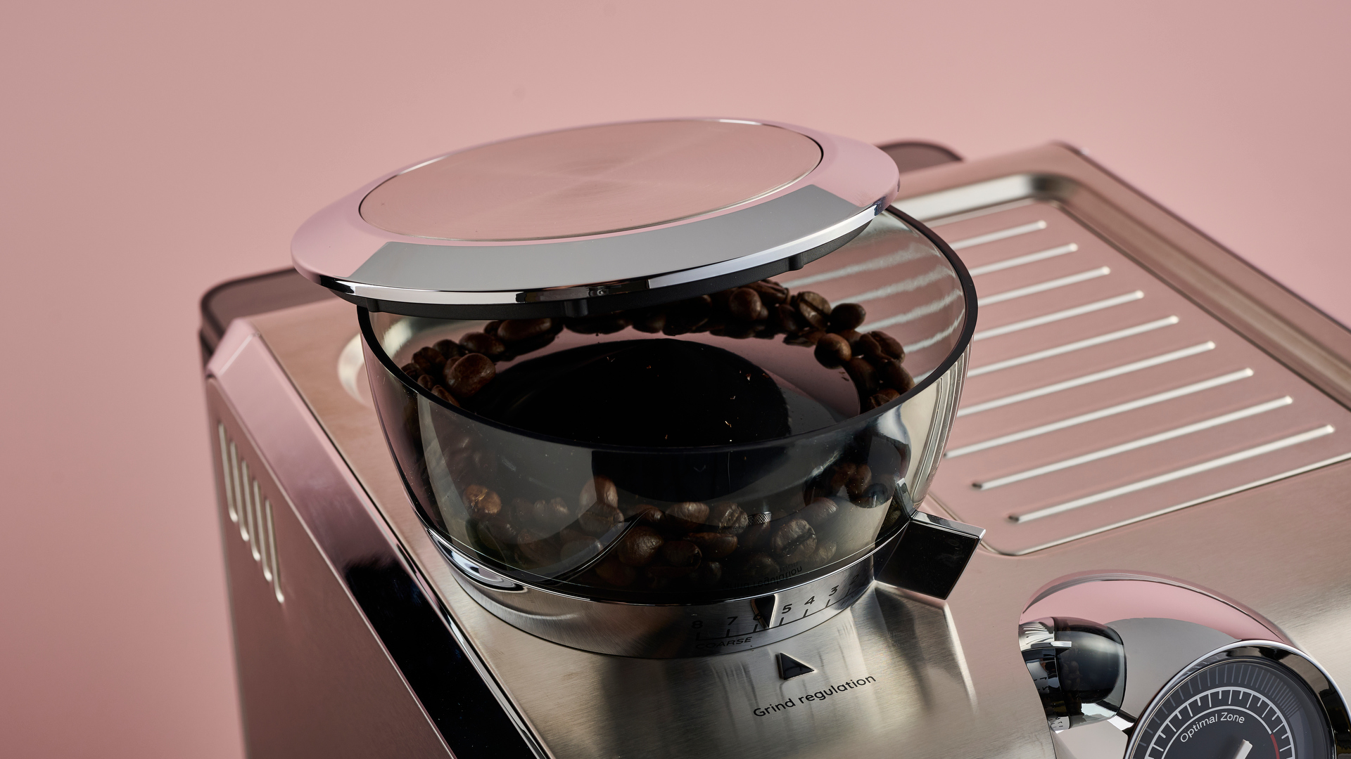 A close-up of the hopper and the conical burr grinder within it.