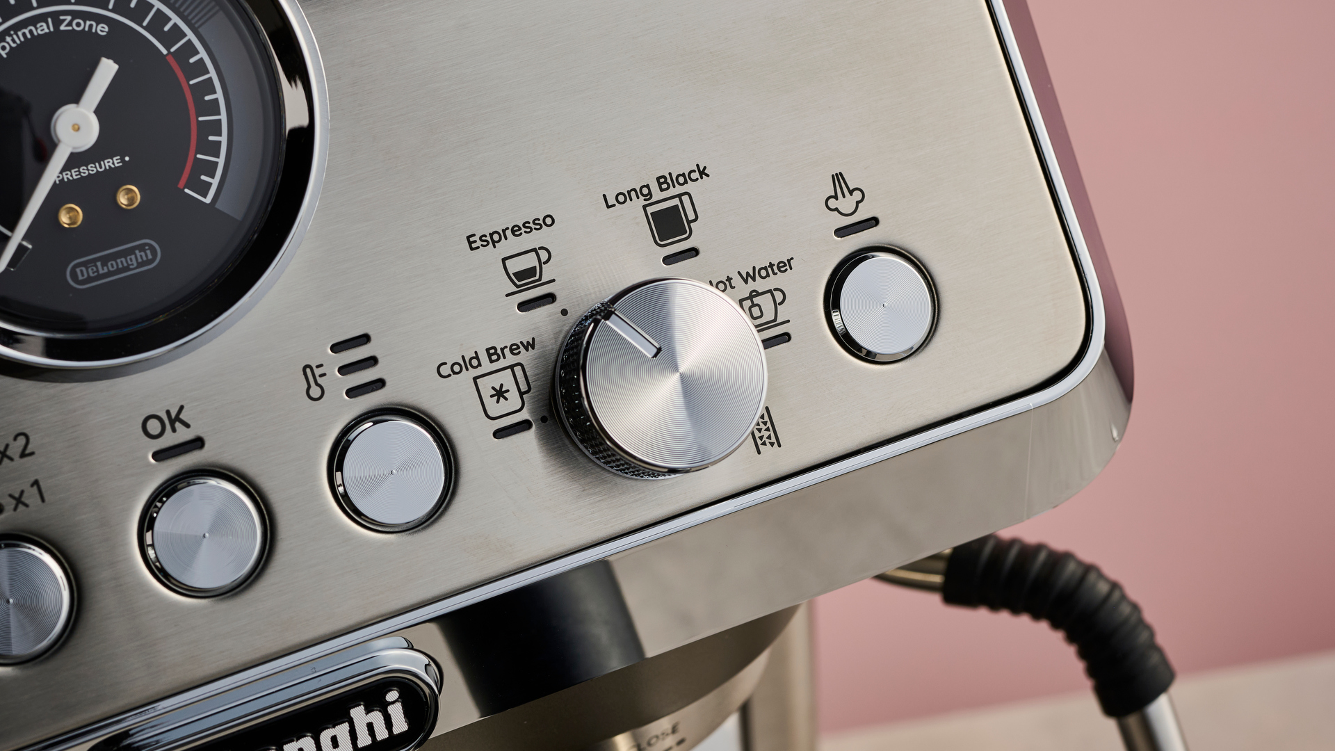 A close-up view of the OK, temperature, and steam arm buttons, along with the dial to select drink types.