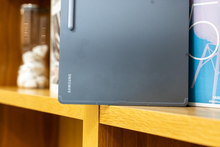 Samsung Galaxy Tab S10 Ultra on a bookshelf.