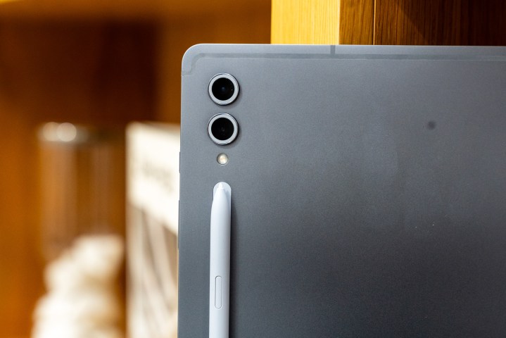 Samsung Galaxy Tab S10 Ultra on a bookshelf.