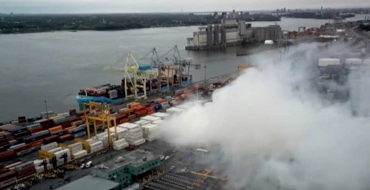 Smoke can be seen from a fire started in a container of 15,000 kilowatts of lithoum ion batteries.