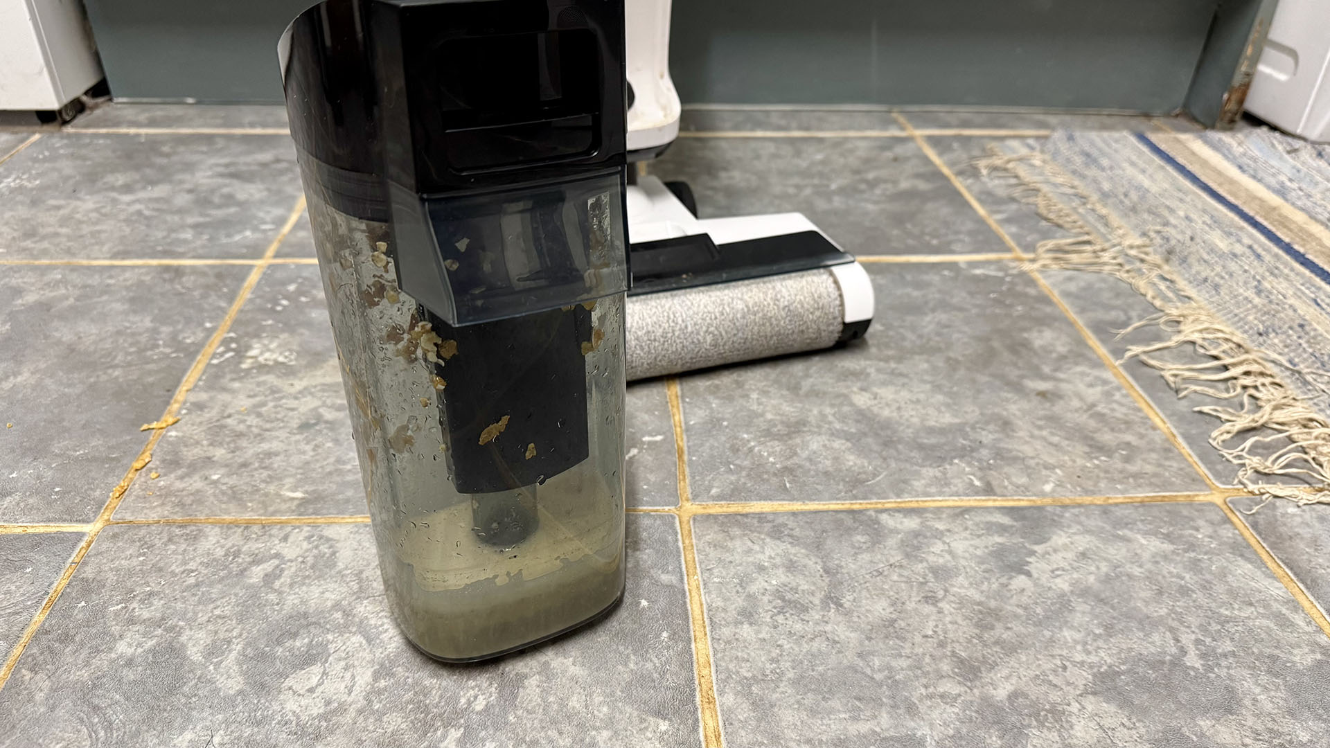 Water tank on Gtech Orca hard floor cleaner, removed, full of dirty water