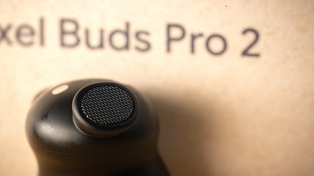 Close-up of a Google Pixel Buds Pro 2 earbud with a textured mesh speaker.