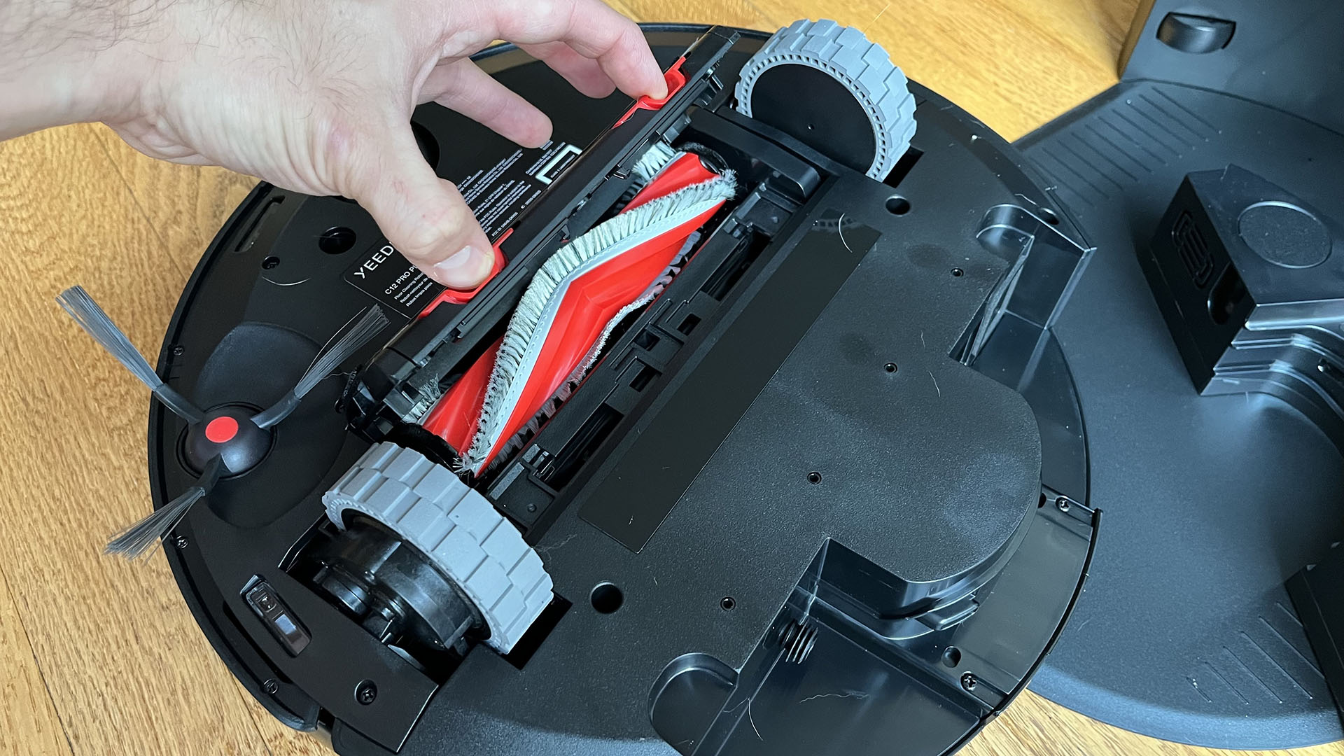 Yeedi C12 Pro Plus robot vacuum flipped over to show brushroll