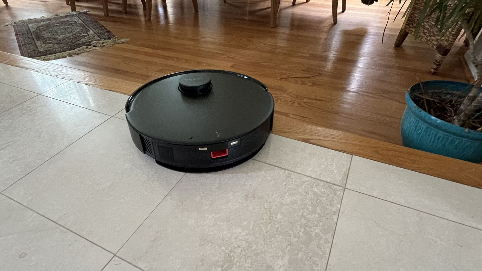 Yeedi C12 Pro Plus robot vacuum stopping next to a step down