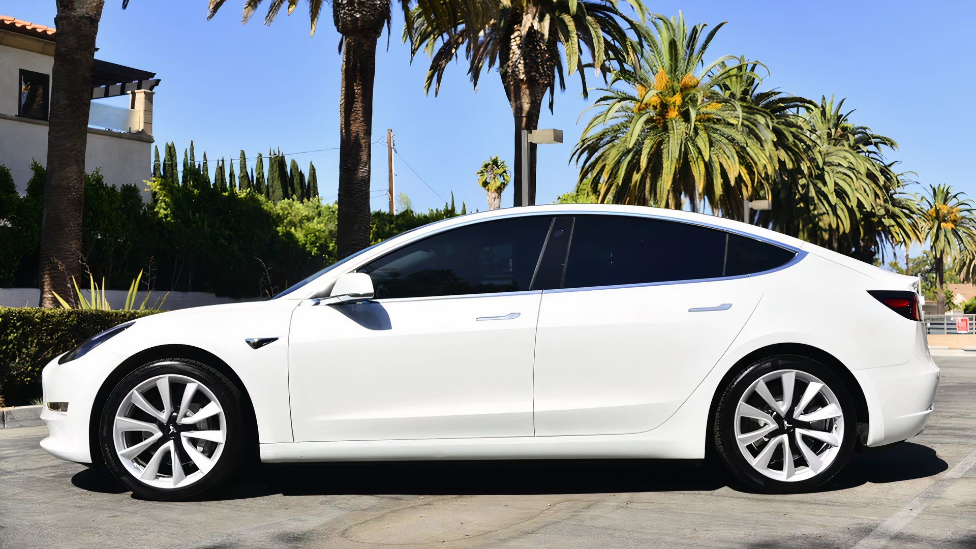 Side profile shot of a white 2019 Tesla Model 3