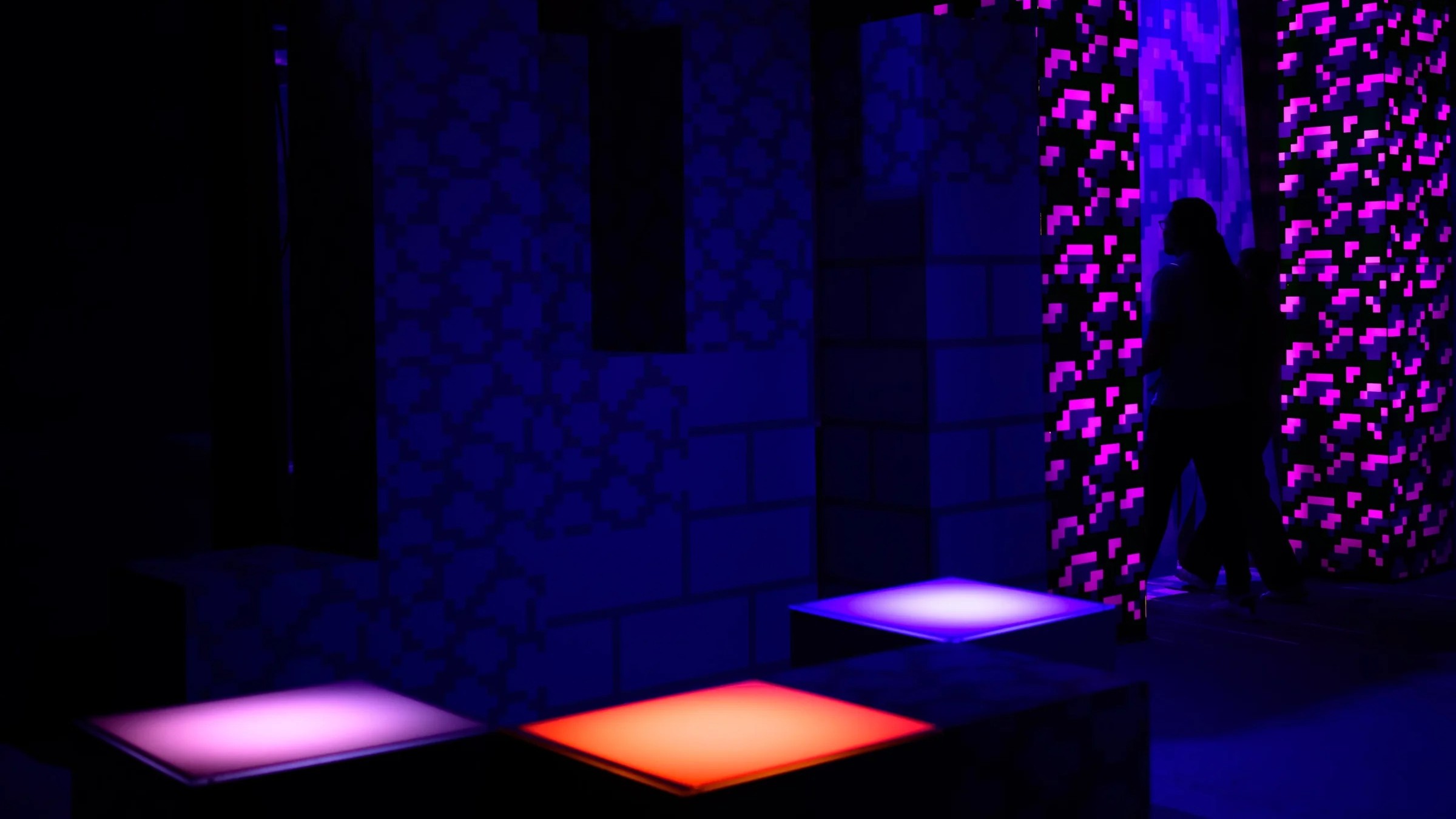 Someone stepping into a Nether portal with glowing squares in the foreground.