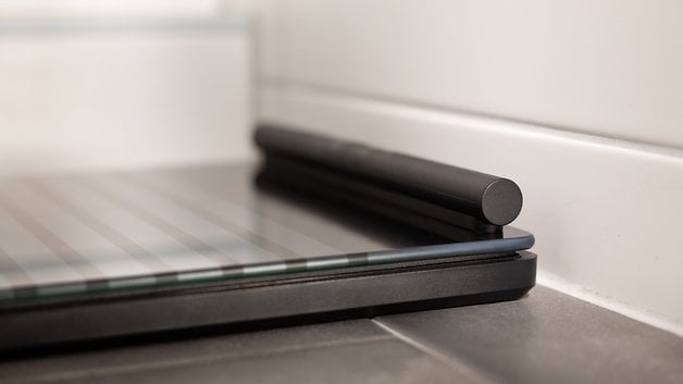 Close-up of a Withings Body Scan smart scale on a tiled floor.