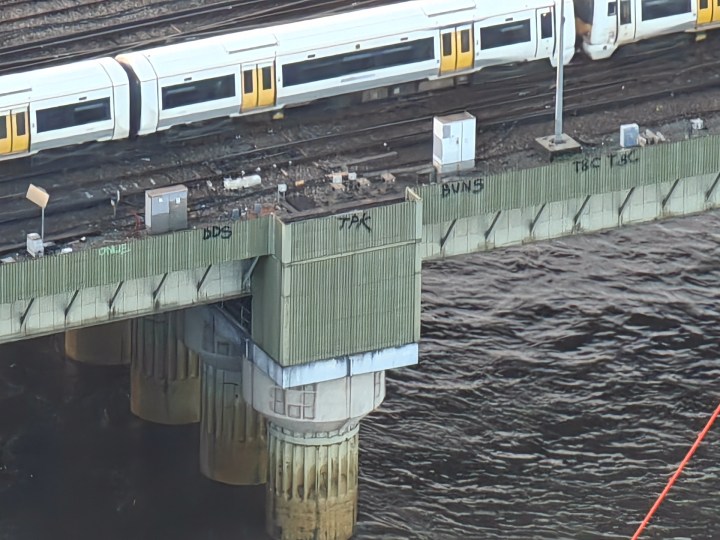 Photo taken at 30x zoom on the Oppo Find X7 Ultra showing graffiti on the side of a bridge in London.