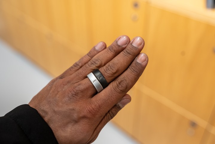 Oura Ring 4 and Oura Ring 3 on two fingers.