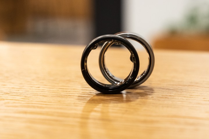 Oura Ring 3 in front of the Oura Ring 4 to show the difference in sensor design.