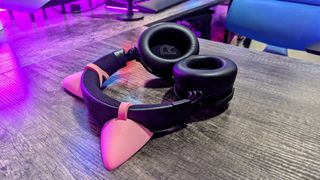 The Razer Kraken V4 Pro lying on a desk with its earcups facing up, highlighting the large 