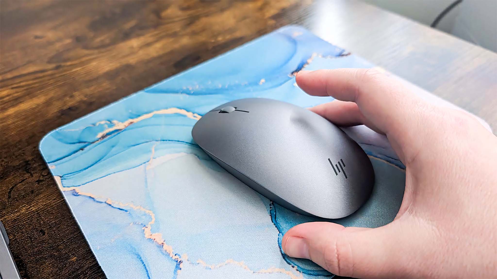 Image showing a hand hovering over the HP OmniStudio X mouse. 