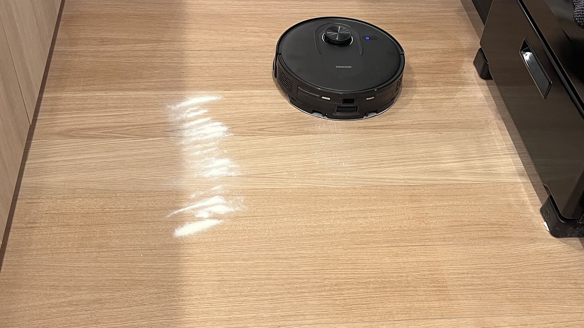 Proscenic Q8 Max robot vacuum after cleaning oats from a hard floor