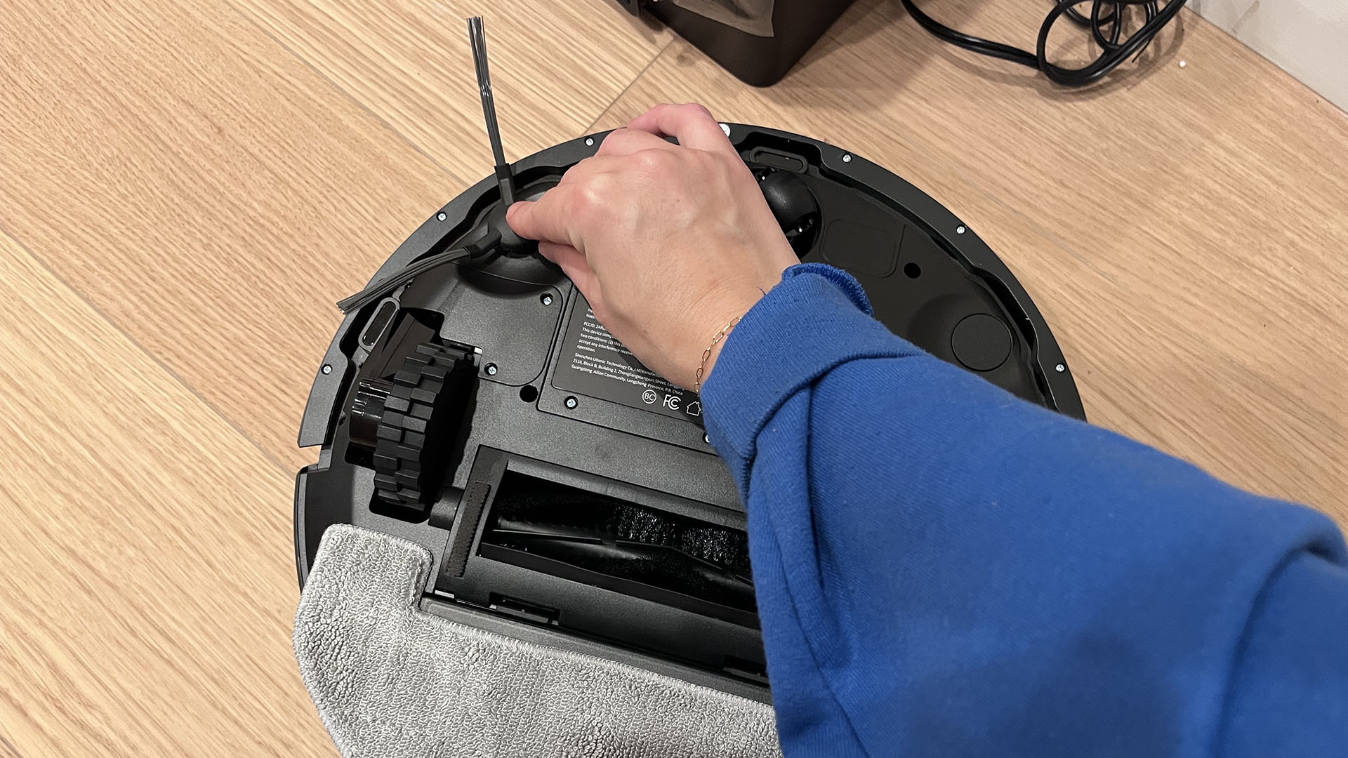 Reviewer attaching side brush to Proscenic Q8 Max robot vacuum