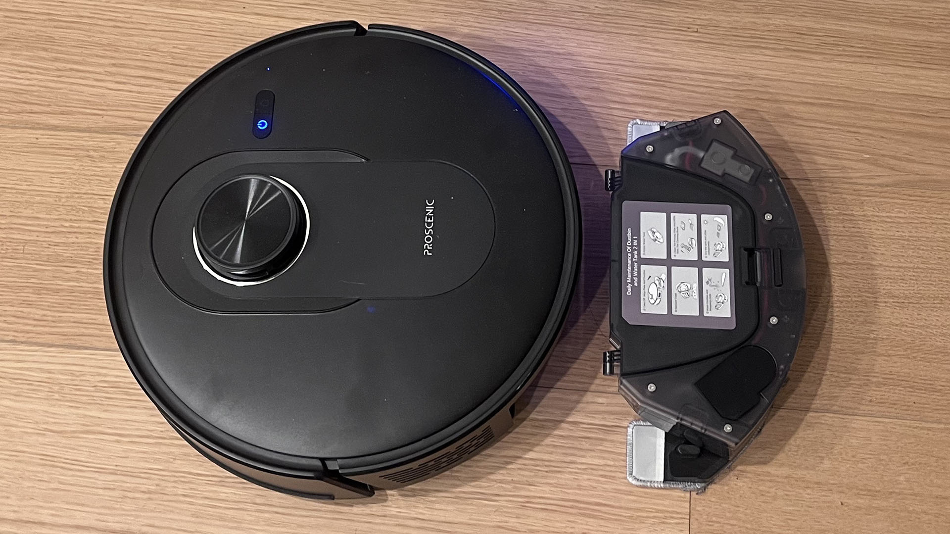 Proscenic Q8 Max robot vacuum with its onboard dust cup removed and placed alongside