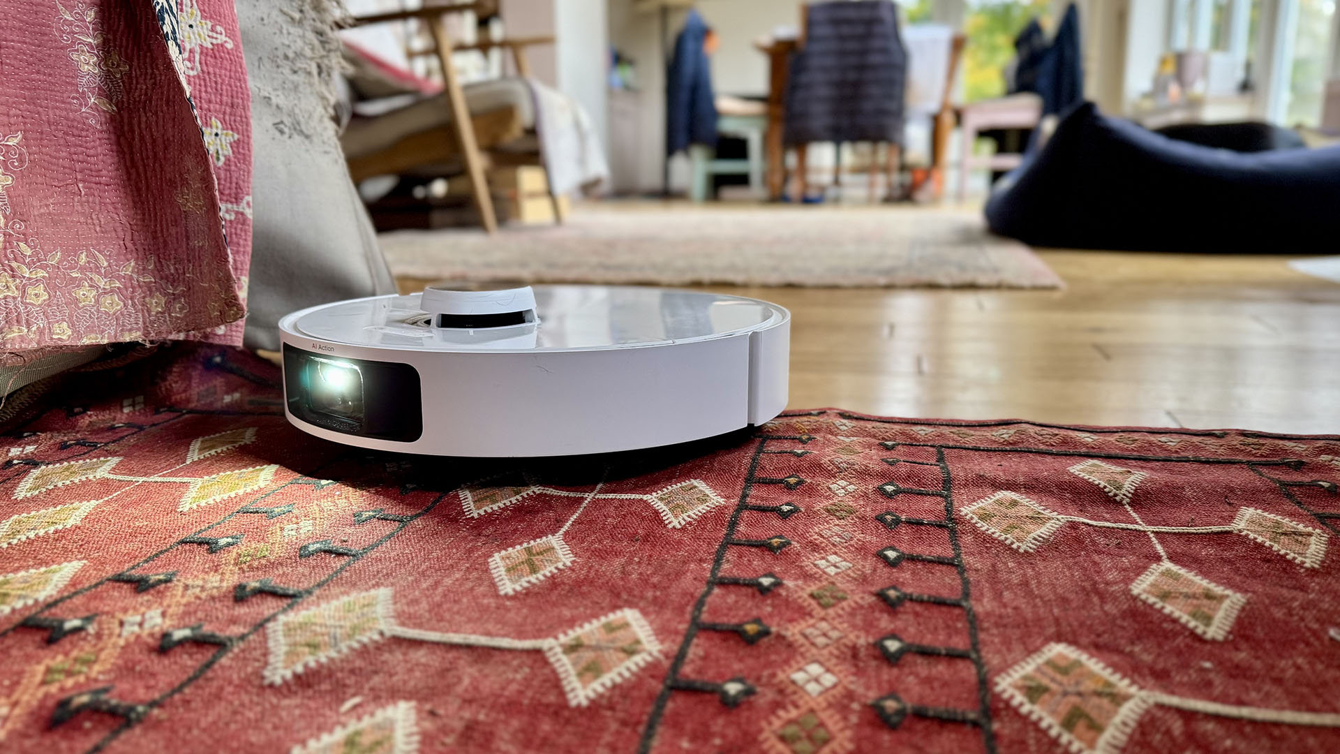 Dreame L40 Ultra robot vacuum cleaning over a loose rug