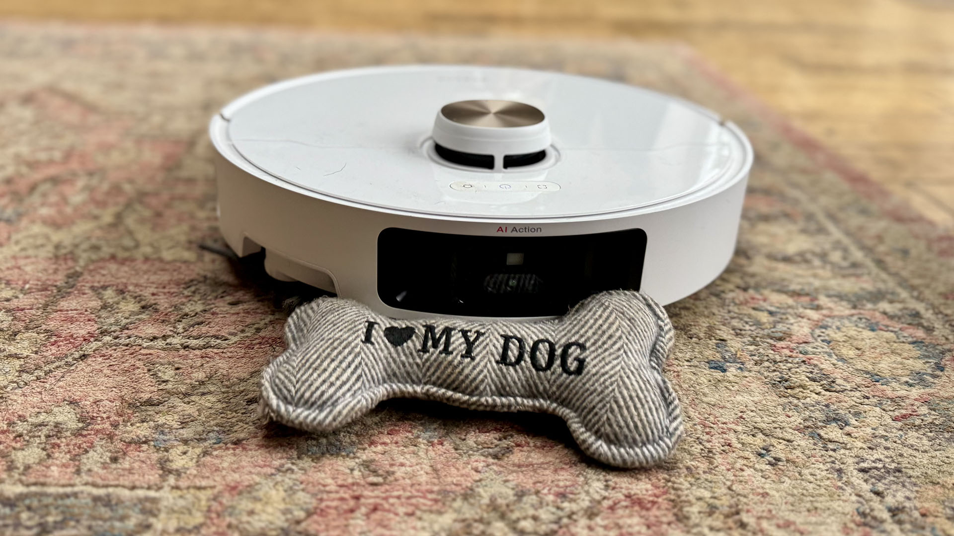 Dreame L40 Ultra robot vacuum on a rug with a dog toy