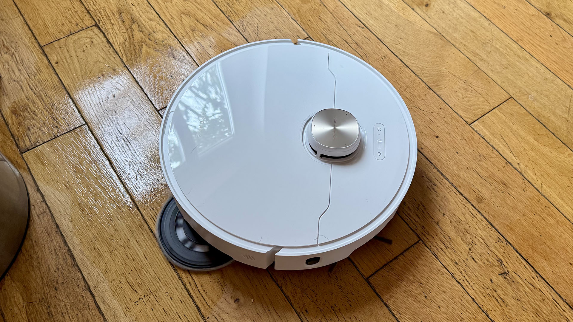 Dreame L40 Ultra robot vacuum mopping a floor with mop pad sticking out