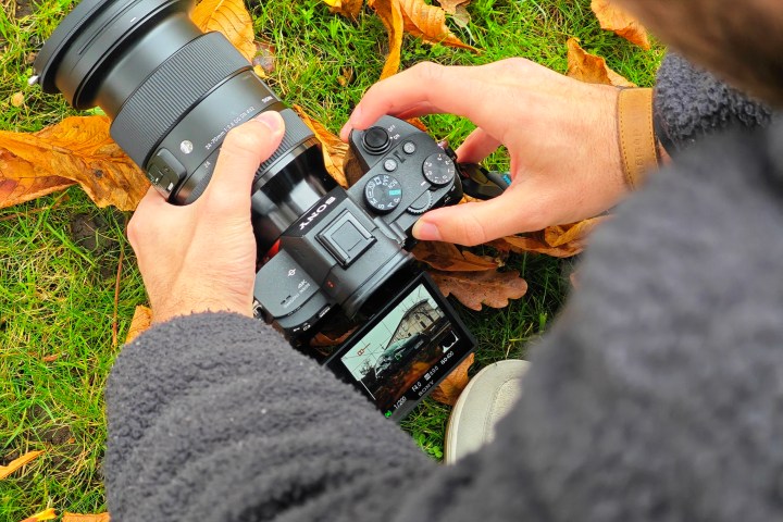 A person taking a photo of a car.